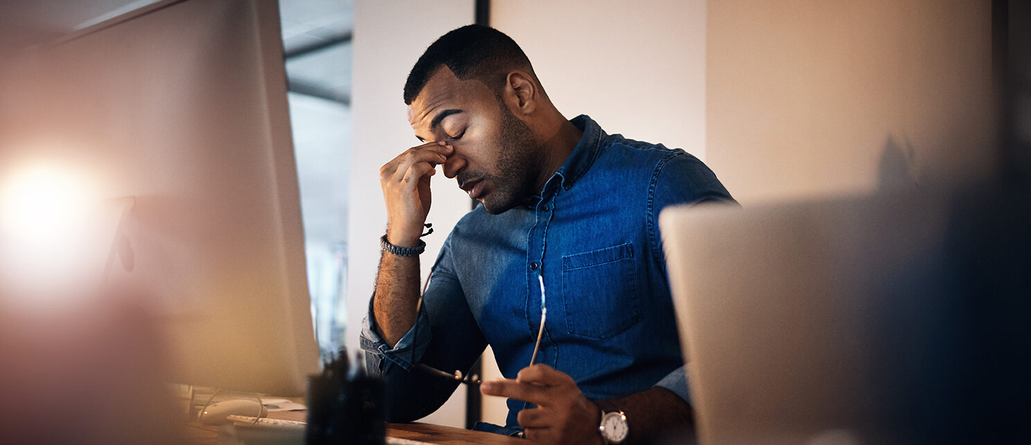 Headache, eye strain and businessman in the office at night working on deadline project. Burnout, stress and professional male employee with migraine doing research on computer overtime in workplace